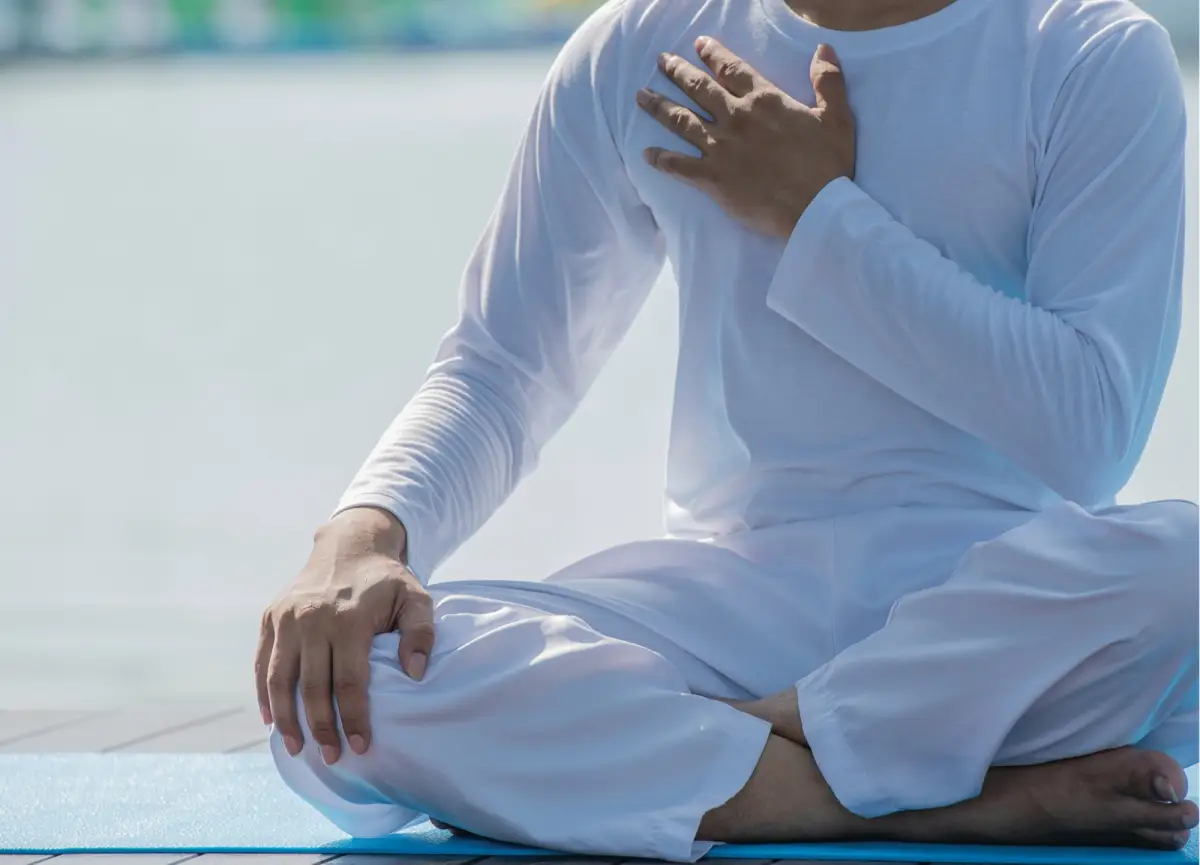 Seated participant during an outdoor Yoga Synergy session